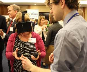 Colin Lea explains the virtual reality interface to Anita Benjamin of the American Mathematical Society.