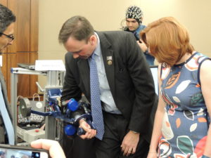 Rep. Pete Olson (R-TX) is shown the robotics demonstration by Marica O'Malley of Rice University. 